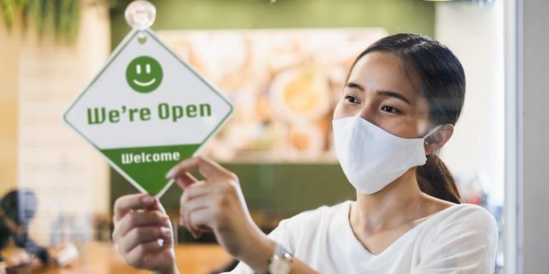 Female small business owner reopening after COVID-19 coronavirus closure
